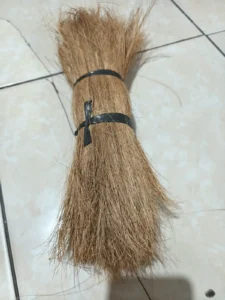 Close-up of a bundled tuft of coco bristle fiber tied for grading