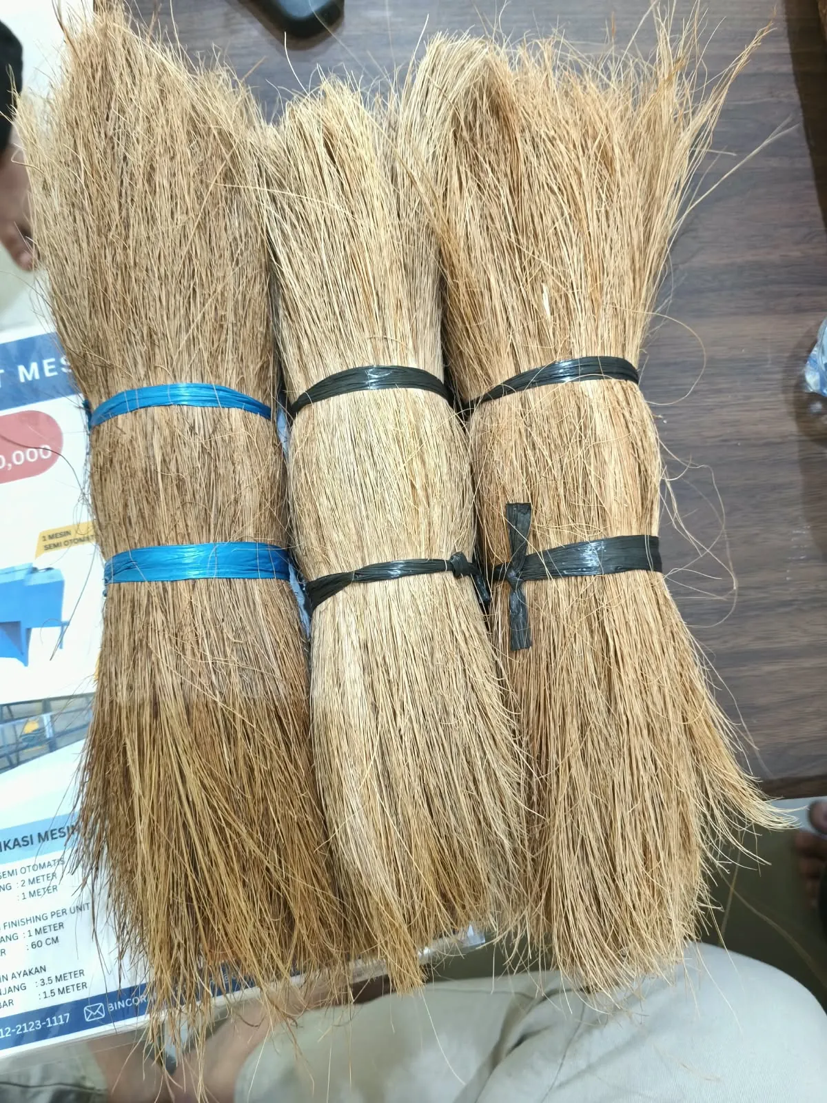Three bundled tufts of coco bristle fiber shown side by side for grading comparison